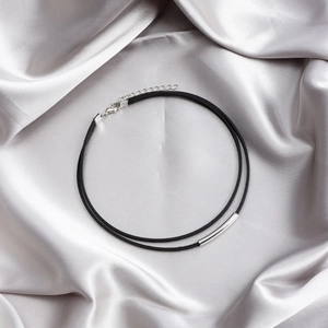 Minimalist double layer black suede choker with sleek silver metal tube on satin