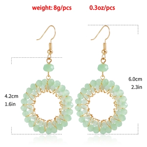 Detail view of woven mint green crystal hoop earrings with dimensions and weight specs