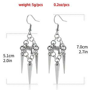 Detail shot of Gothic tassel earring featuring silver thorns, rings, and spike pendants