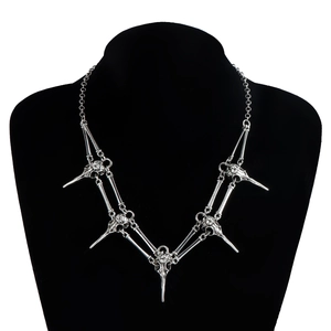 Gothic silver bird skull necklace with five skeletal pendants on a black display stand