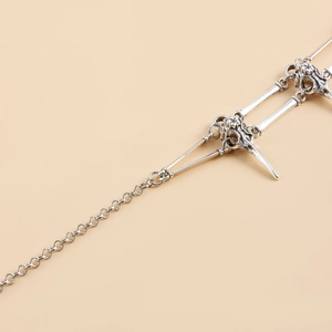 Detailed close-up of gothic bird skull pendant with vintage silver finish and chain