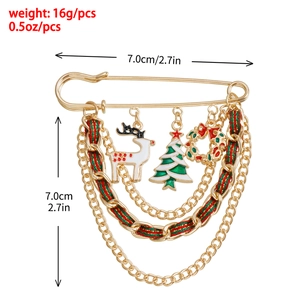 Christmas reindeer and tree brooch with gold metal chains and enamel charms on white background