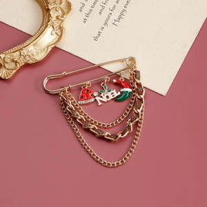 Detail of Christmas safety pin brooch with Noel pendants and colorful tassel chains
