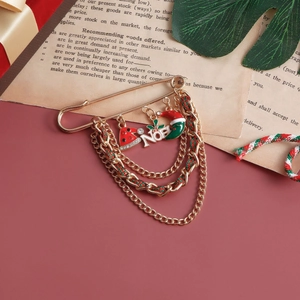 Christmas layered chain brooch with Noel charms and red green enamel pendants on gold pin