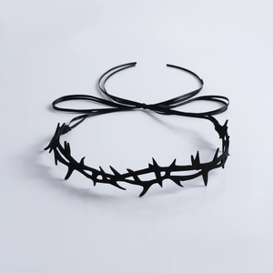 Detailed view of gothic thorn-shaped headband with black silk ribbons for styling