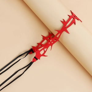 Macro shot of red felt thorn choker with adjustable black ribbon on beige stand