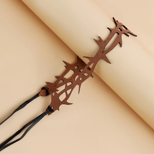 Gothic thorns choker detail with matte brown leather texture and black woven laces