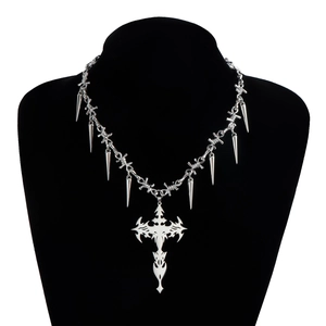 Detailed view of silver punk choker featuring thorn spikes and tribal cross pendant