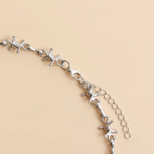 Close-up of barbed wire chain necklace with lobster clasp and adjustable links