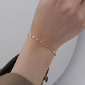 Minimalist gold titanium steel lip chain bracelet with shimmering water wave texture