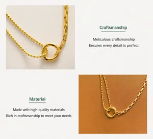 Detail of gold geometric necklace showing unique ball chain and box chain textures