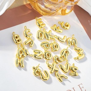 3D bubble-style 18K gold plated stainless steel initial pendants set on white background