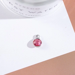 Macro shot of rose red faceted crystal pendant with silver setting for DIY jewelry