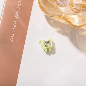 Mini green butterfly hair claw clip with sparkling rhinestones for elegant styling