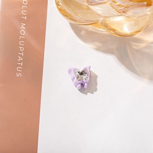 Detail of lavender butterfly hair claw clip featuring a sparkling center rhinestone