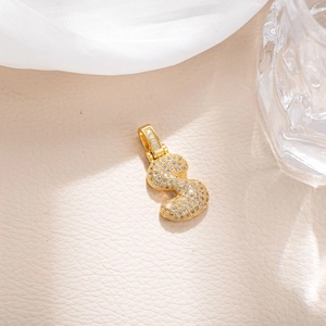Macro shot of gold-plated number 3 pendant with sparkling pave cubic zirconia