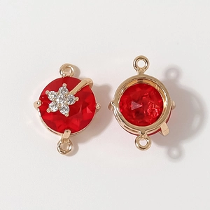 DIY jewelry connector with red faceted gemstone and silver flower detail in gold frame