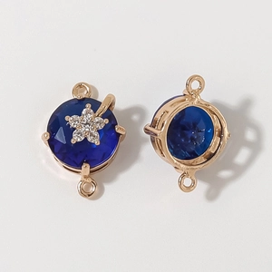 Golden round jewelry connector with deep blue faceted gemstone and starry zircon accents