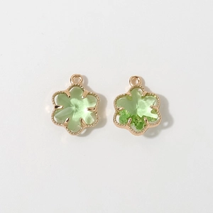 Detail of 12mm gold plated flower pendant with green glass stone for DIY jewelry making