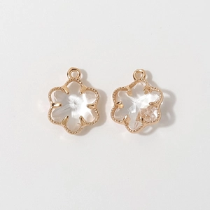 Detail of 12mm gold-plated floral pendants with transparent faceted glass crystals