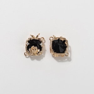 Golden lotus flower scarf ring with black gemstone inlay and sparkling crystals