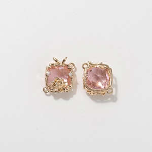 Macro detail of square pink gemstone scarf buckle with golden lotus and side loops