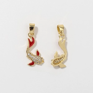 Macro detail of koi carp pendant with gold base, red enamel fins and sparkling zircon inlay
