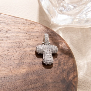 Macro shot of silver capital letter T pendant with pavé cubic zirconia setting