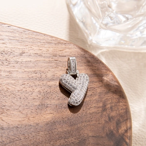 Macro shot of a silver letter Y pendant with cubic zirconia in hip hop style