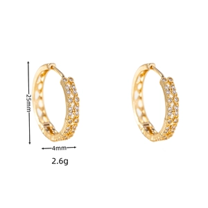 Detail view of 25mm gold hoop earrings featuring lattice design and cubic zirconia