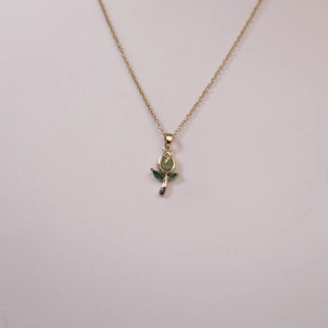 Elegante collar con colgante de tulipán dorado con gemas verdes y detalles de hojas