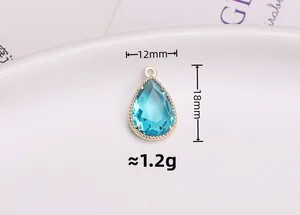 Detail of a 12x18mm light blue crystal teardrop pendant with gold-plated metal edge