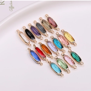 Macro detail of various colorful navette cut crystal pendants with gold plated borders