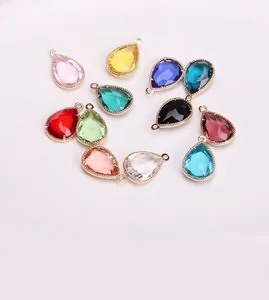 Macro view of teardrop glass pendants in multiple colors with gold-plated copper loops