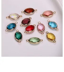 Close-up of colorful oval crystal connectors with gold-plated frames for DIY jewelry