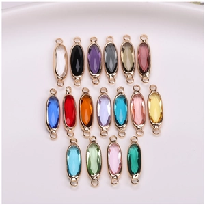 Macro view of 17 colorful oval crystal charms with gold plated frames for DIY jewelry