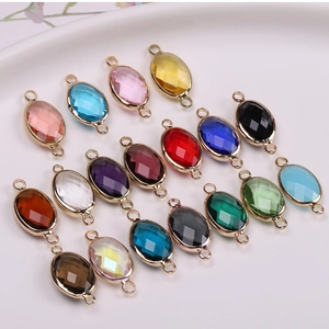 Macro view of oval crystal connectors in various colors with gold plated metal frames