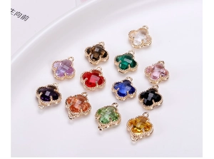 Detail showing 12 colors of clover shaped faceted crystals with golden metal frames