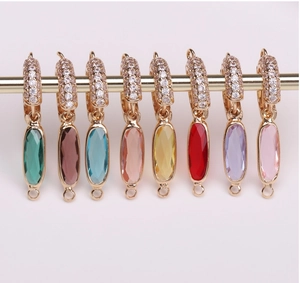 Detailed row of eight colorful oval crystal charms with gold-plated edges and zircon hooks