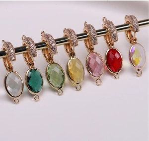 Detail of colorful oval crystal pendants with gold connectors for DIY jewelry making