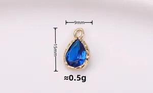 Macro shot of 15mm blue waterdrop pendant with gold plating and size measurements