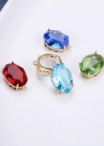 Detail of oval crystal pendants in gold plated copper setting with various colors