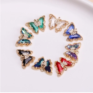 Macro detail of butterfly crystal pendants in eight colors with gold metallic borders