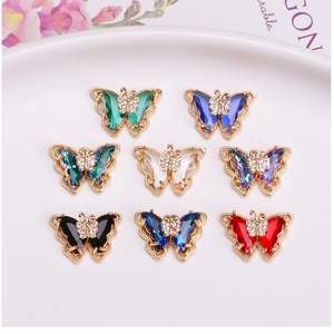 Macro shot of colorful crystal butterfly pendants in eight vibrant shades with metal base