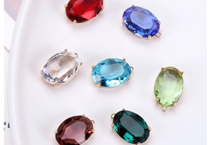 Detailed view of colorful oval crystal pendants in gold plated copper claw settings