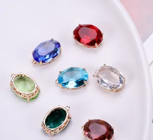 Detail of colorful oval crystal charms with gold plating and ornate filigree edges