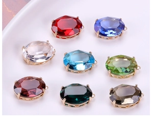 Close-up of eight multicolored oval faceted crystal pendants with gold-plated claw settings