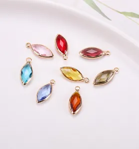 Macro detail of eight-color marquise crystal glass charms with gold-plated copper base