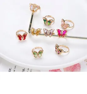 Detailed close-up of 18K gold plated butterfly rings with colorful crystal stones