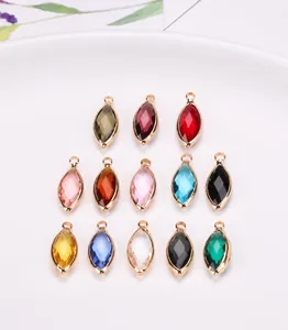Detailed macro view of assorted marquise crystal glass pendants with gold plated edges